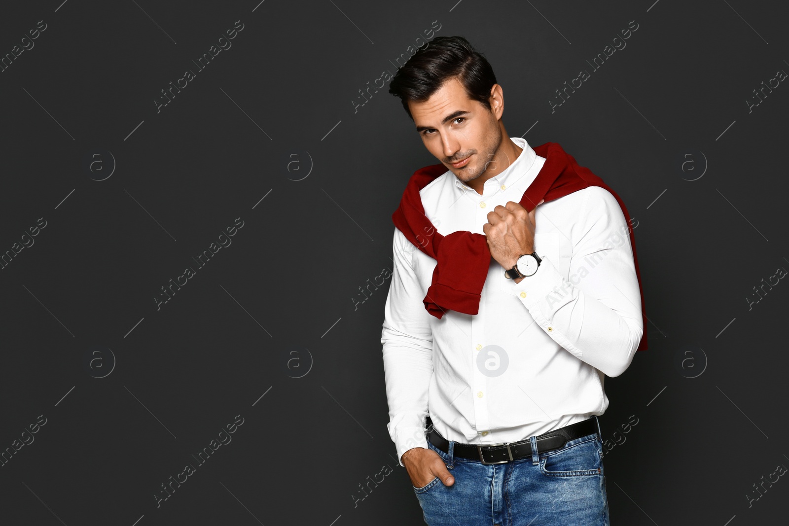 Photo of Portrait of handsome young man on dark background. Space for text