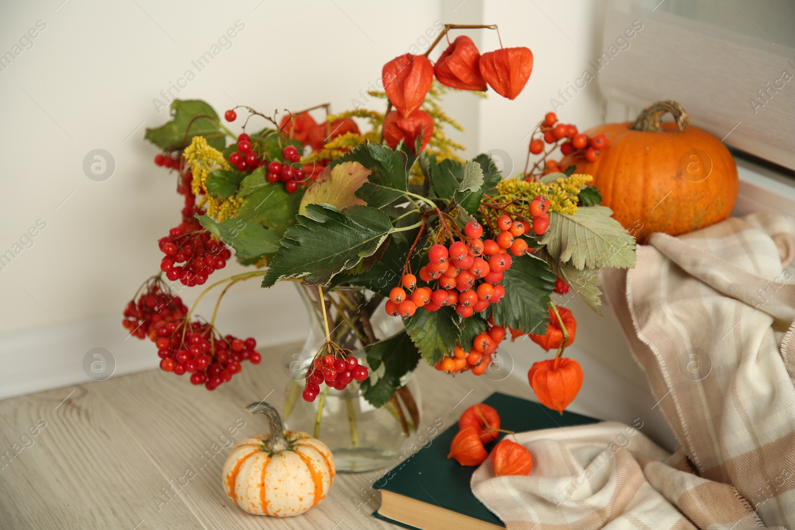 Photo of Beautiful autumn composition with different pumpkins and book indoors