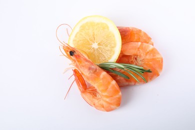 Photo of Delicious cooked shrimps, lemon and rosemary isolated on white