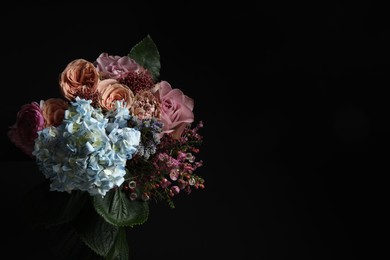 Beautiful fresh flowers on dark background, space for text