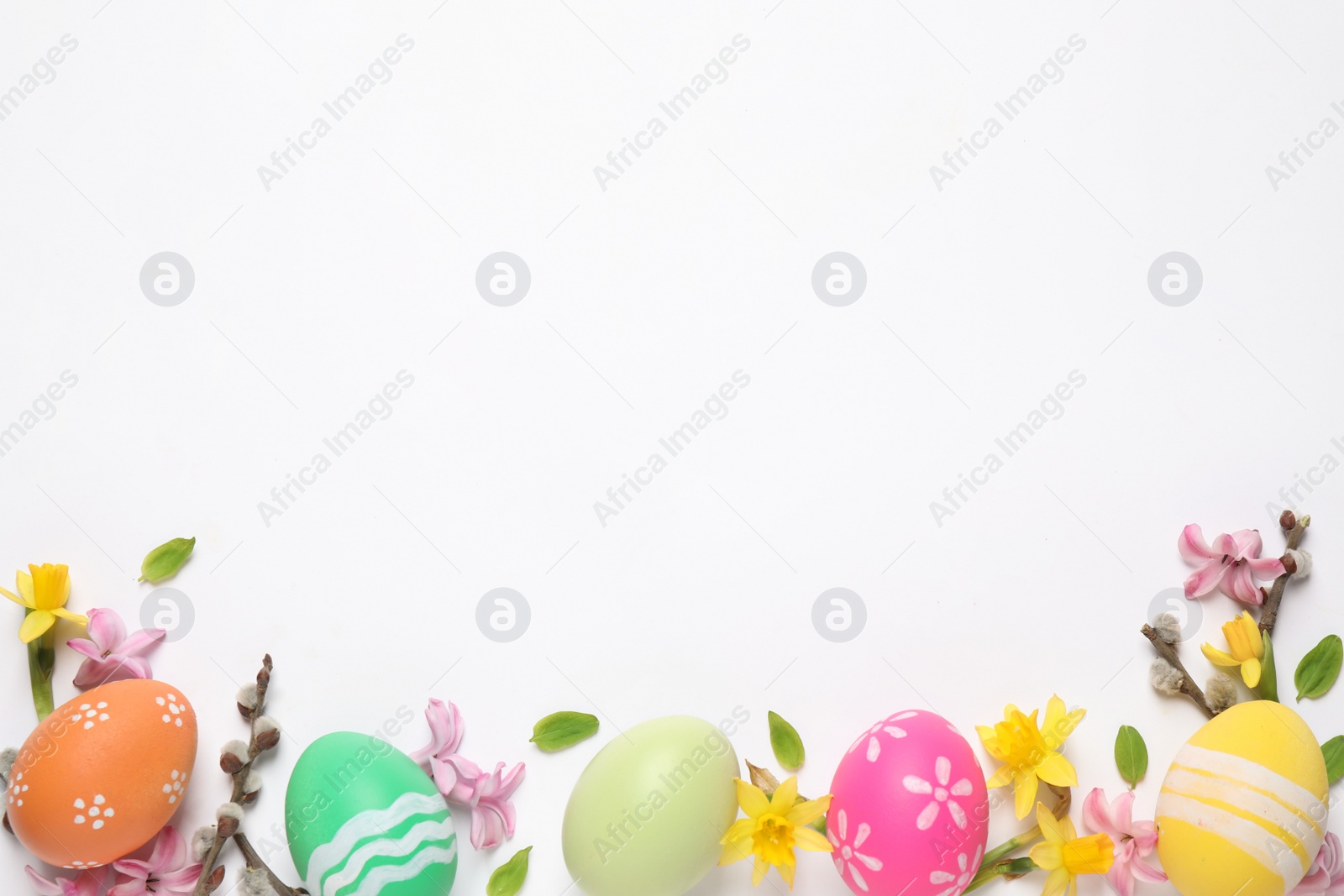 Photo of Flat lay composition with Easter eggs on white background. Space for text