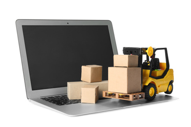 Photo of Laptop, forklift model and carton boxes on white background. Courier service