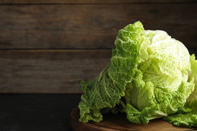 Photo of Fresh ripe Chinese cabbage on black table. Space for text
