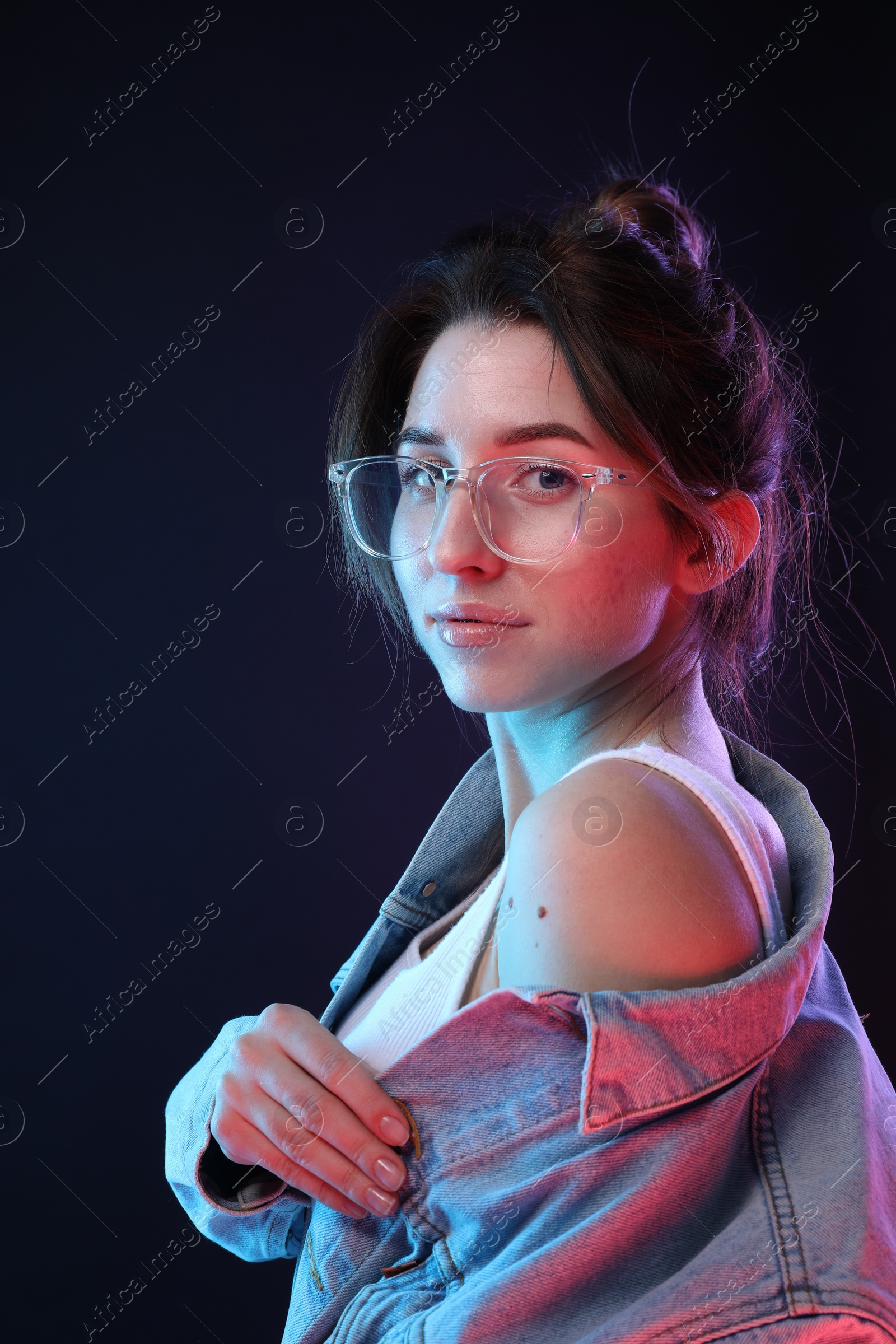 Photo of Portrait of beautiful young woman in glasses on color background