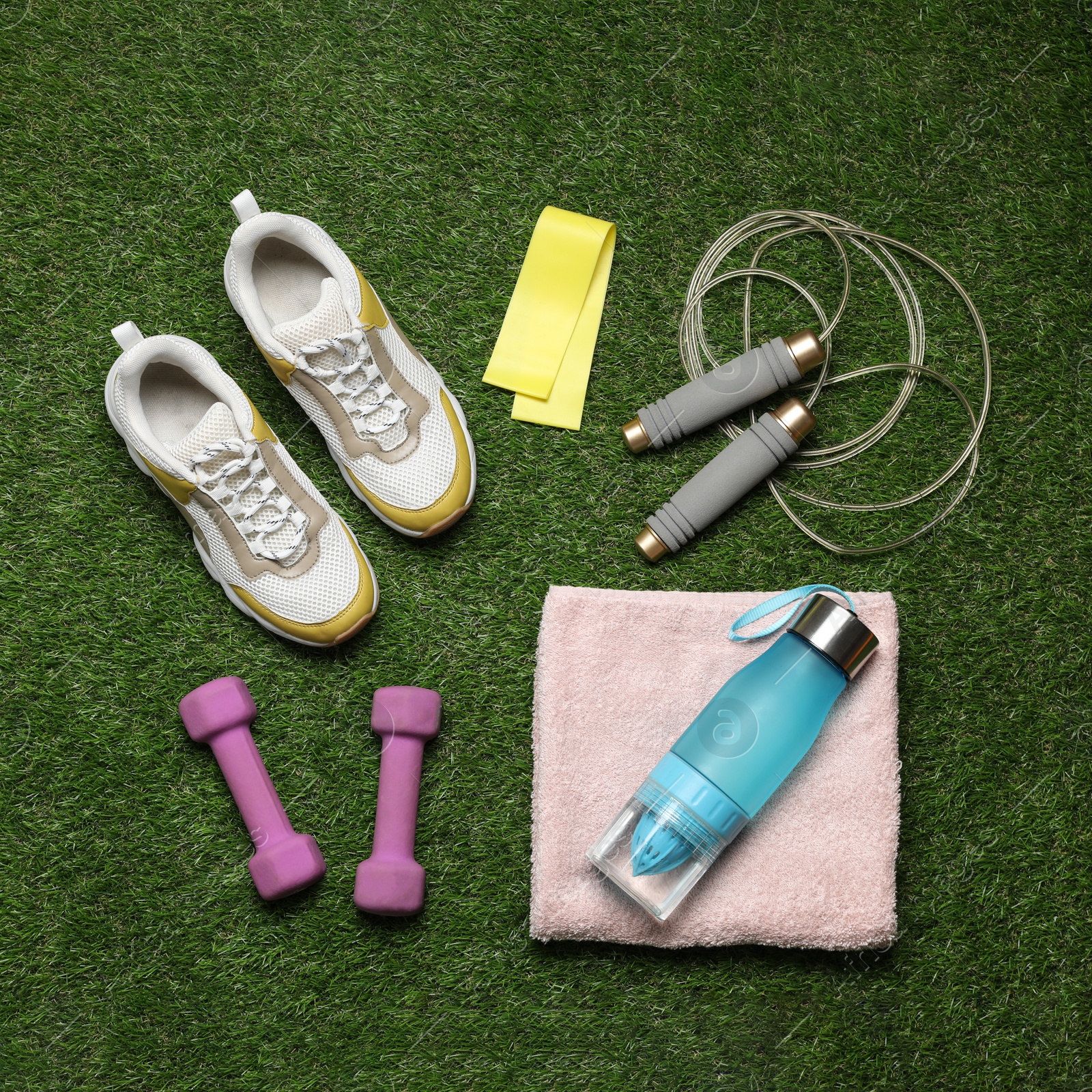 Photo of Flat lay composition with sports equipment on green grass