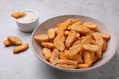 Crispy rusks and dip sauce on light table, closeup