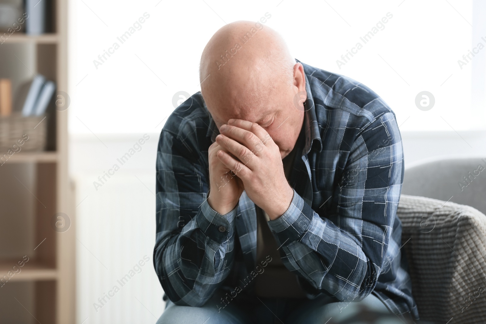 Photo of Senior man in state of depression indoors