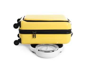 Photo of Weighing stylish suitcase on scales, white background