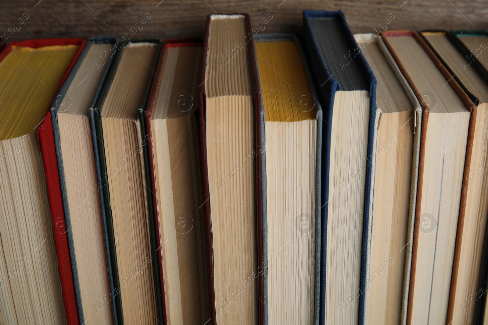 Photo of Stack of hardcover books on wooden background