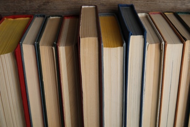 Stack of hardcover books on wooden background