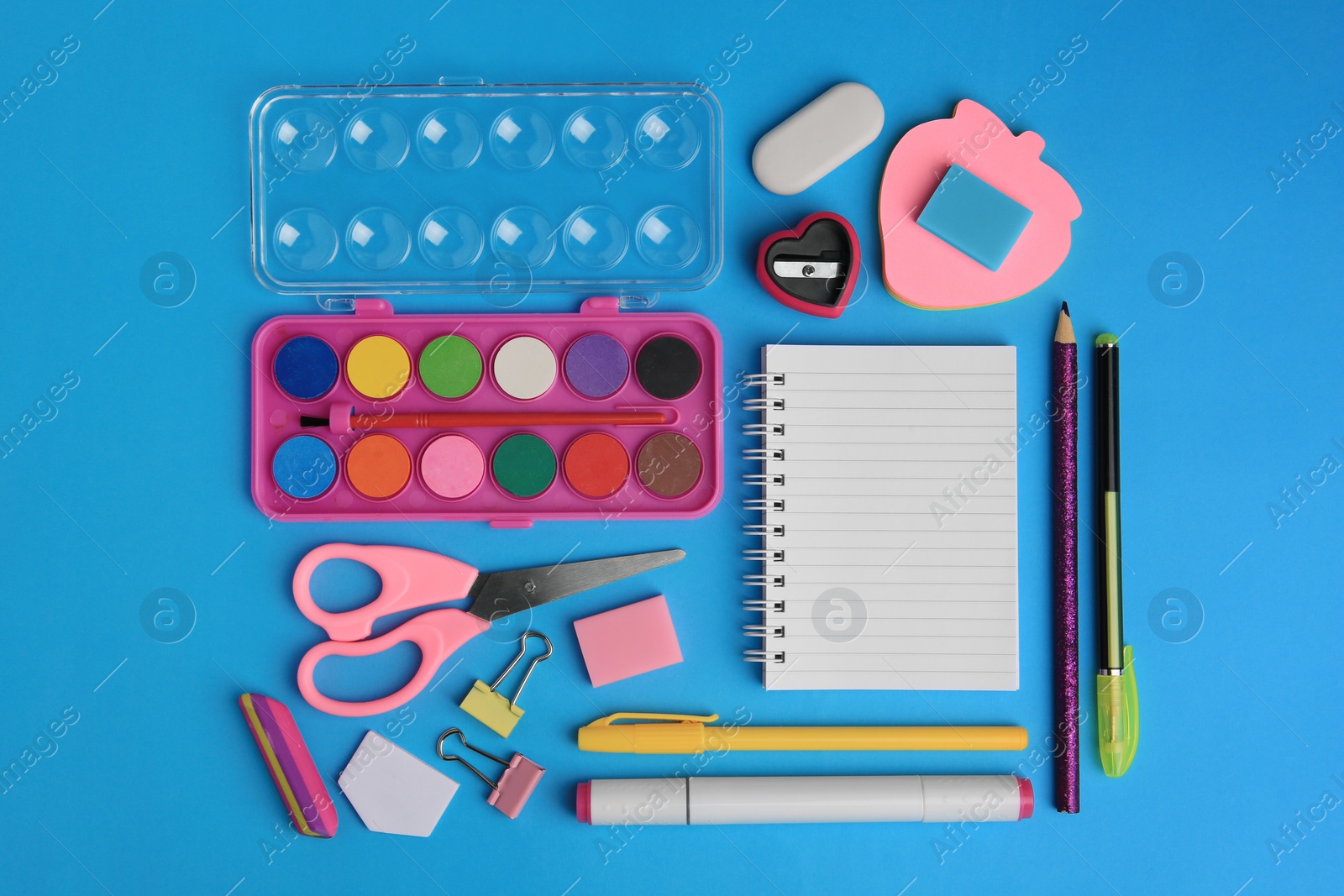 Photo of Flat lay composition with blank notebook and other school stationery on light blue background, space for text. Back to school