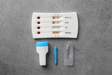 Photo of Disposable multi-infection express test kit on grey table, flat lay