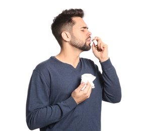 Photo of Man using nasal spray on white background
