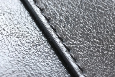 Beautiful grey leather with seam as background, closeup view