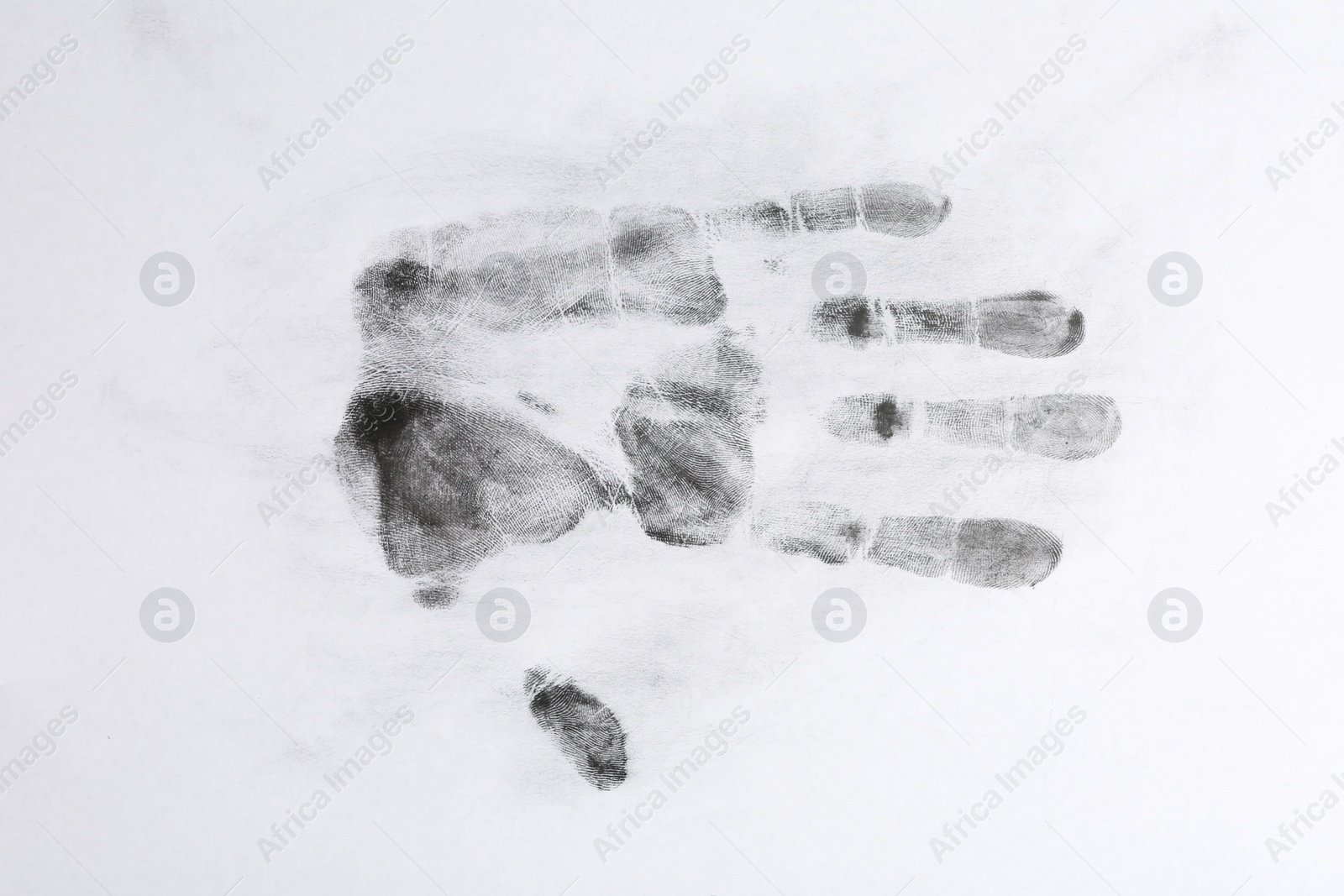 Photo of Print of hand and fingers on white background, top view. Criminal investigation