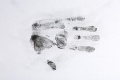 Print of hand and fingers on white background, top view. Criminal investigation