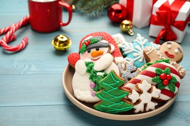 Delicious homemade Christmas cookies and festive decor on turquoise wooden table, closeup