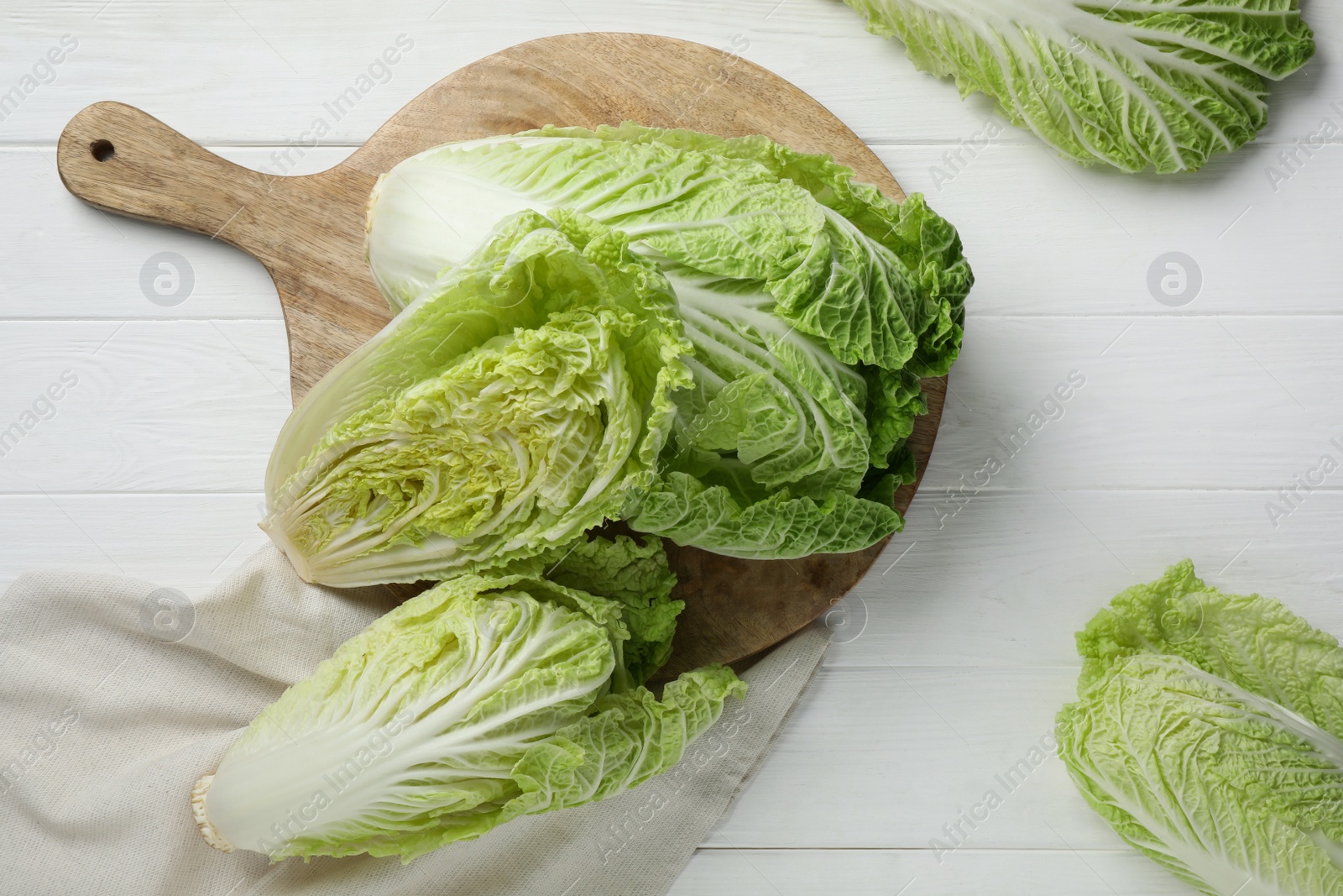 Photo of Fresh ripe Chinese cabbages on white wooden table, flat lay