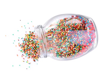 Photo of Colorful sprinkles in jar on white background, top view. Confectionery decor