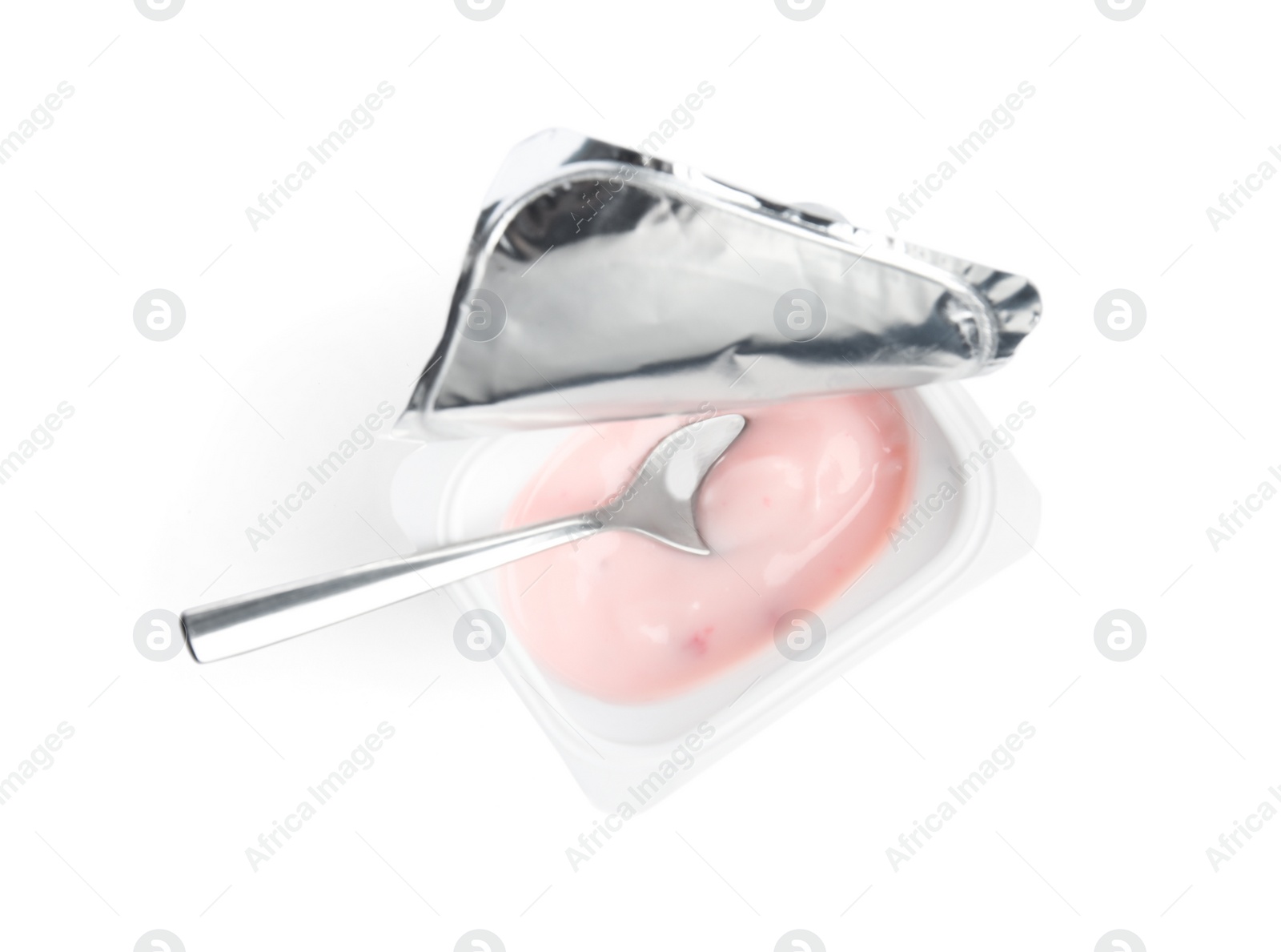 Photo of Tasty organic yogurt in plastic cup with spoon isolated on white, top view