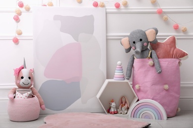 Photo of Beautiful picture and cute toys in baby room. Interior design