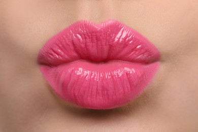 Photo of Closeup view of beautiful woman puckering lips for kiss