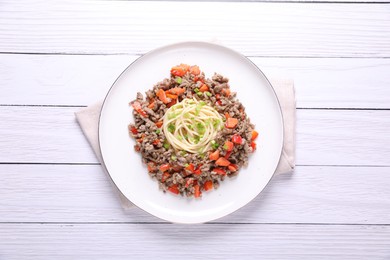 Photo of Tasty minced meat with spaghetti, vegetables and green onion on white wooden table, top view