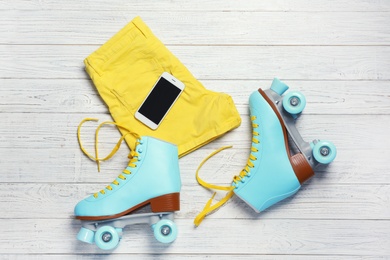 Flat lay composition with quad roller skates on wooden background