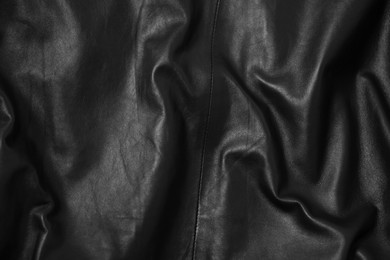 Texture of crumpled black leather as background, top view