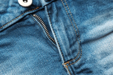 Photo of Closeup view of blue jeans as background