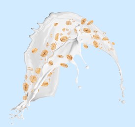 Image of Rolled oats and milk splash on light blue background