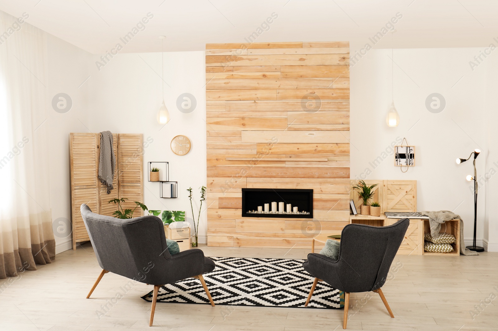 Photo of Living room interior with decorative fireplace in wooden wall