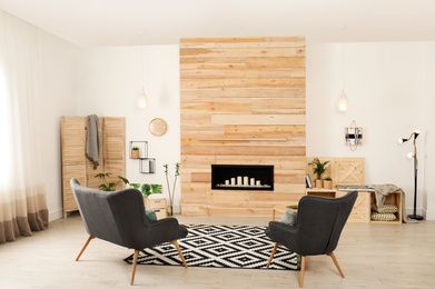 Photo of Living room interior with decorative fireplace in wooden wall