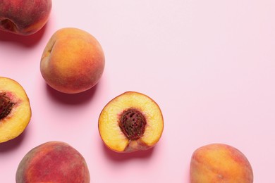 Cut and whole fresh ripe peaches on pink background, flat lay. Space for text