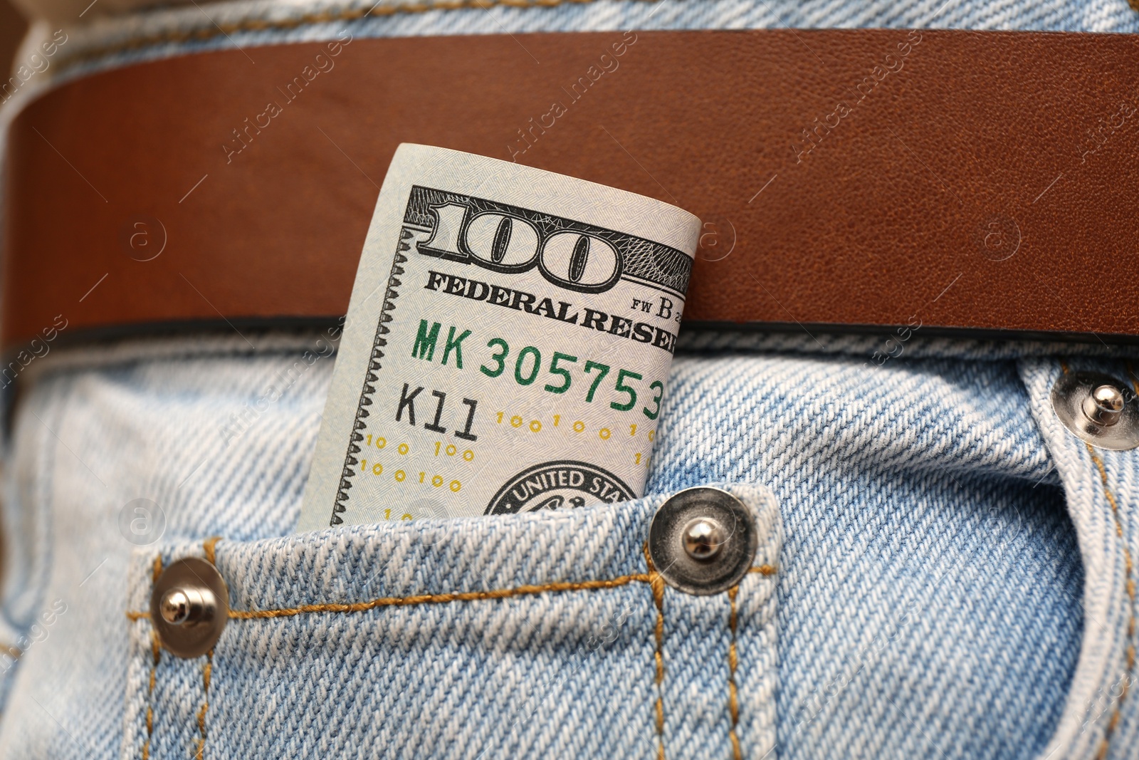 Photo of Dollar banknote in pocket of jeans, closeup. Spending money