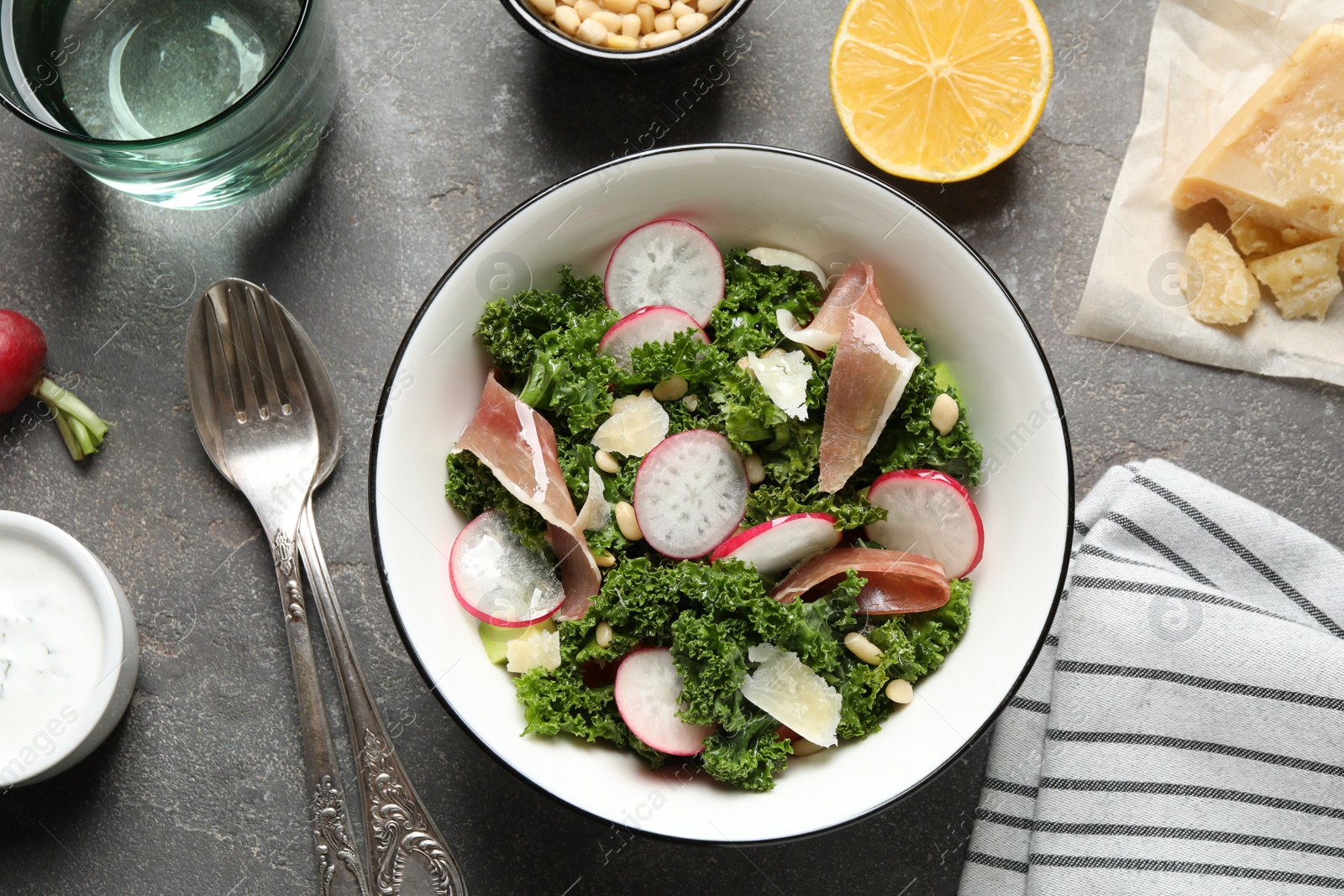 Photo of Tasty fresh kale salad on grey table, flat lay