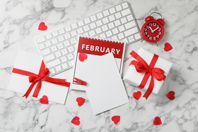 Photo of Flat lay composition with blank card on white marble table, space for text. Valentine's Day celebration