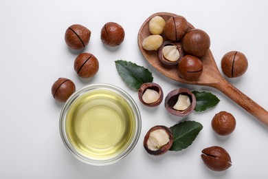 Photo of Delicious organic Macadamia nuts and natural oil on white background, flat lay
