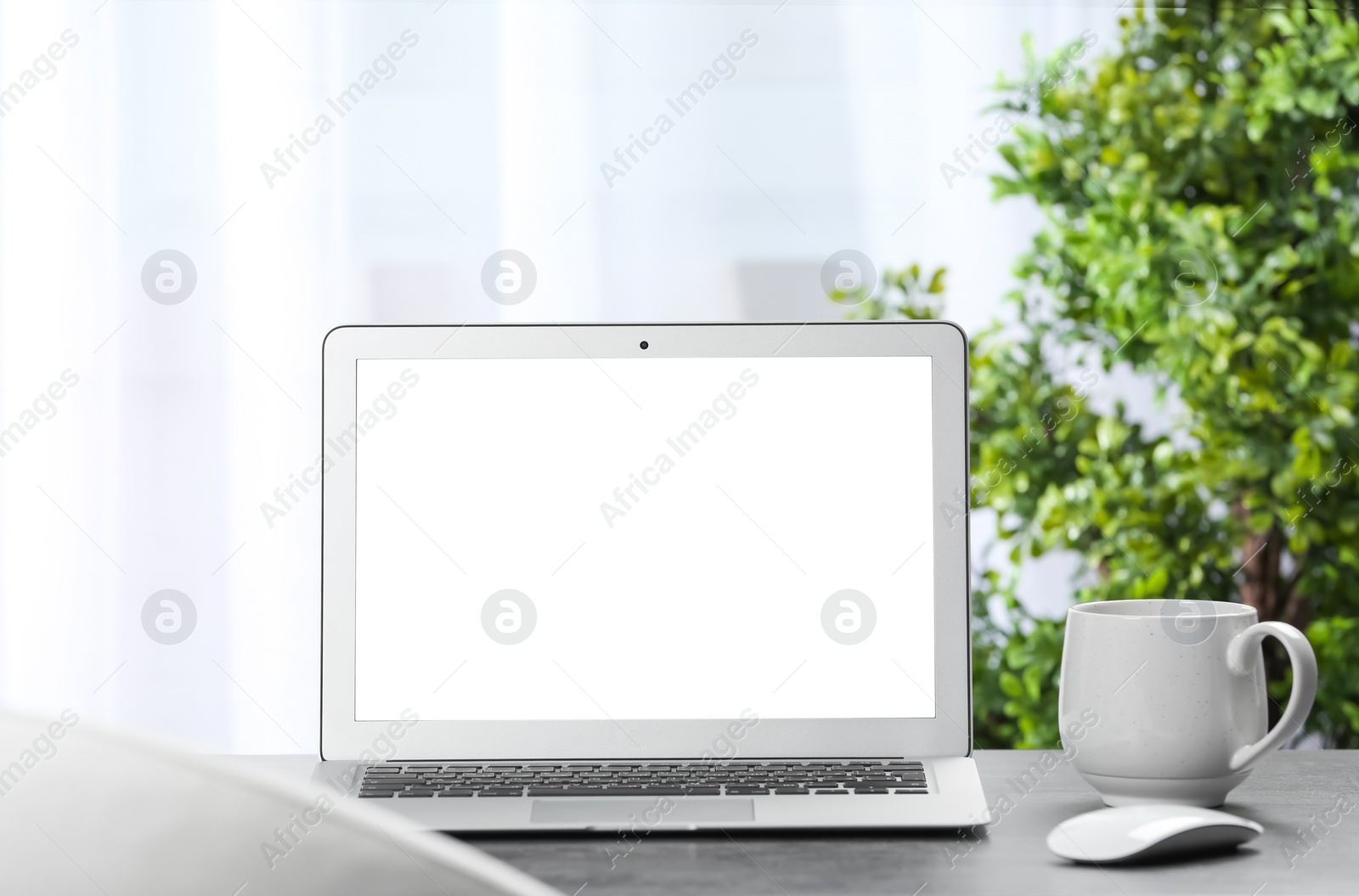 Photo of Laptop on desk in home office. Comfortable workplace