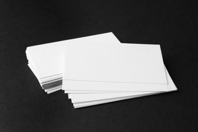 Photo of Blank business cards on black background. Mockup for design