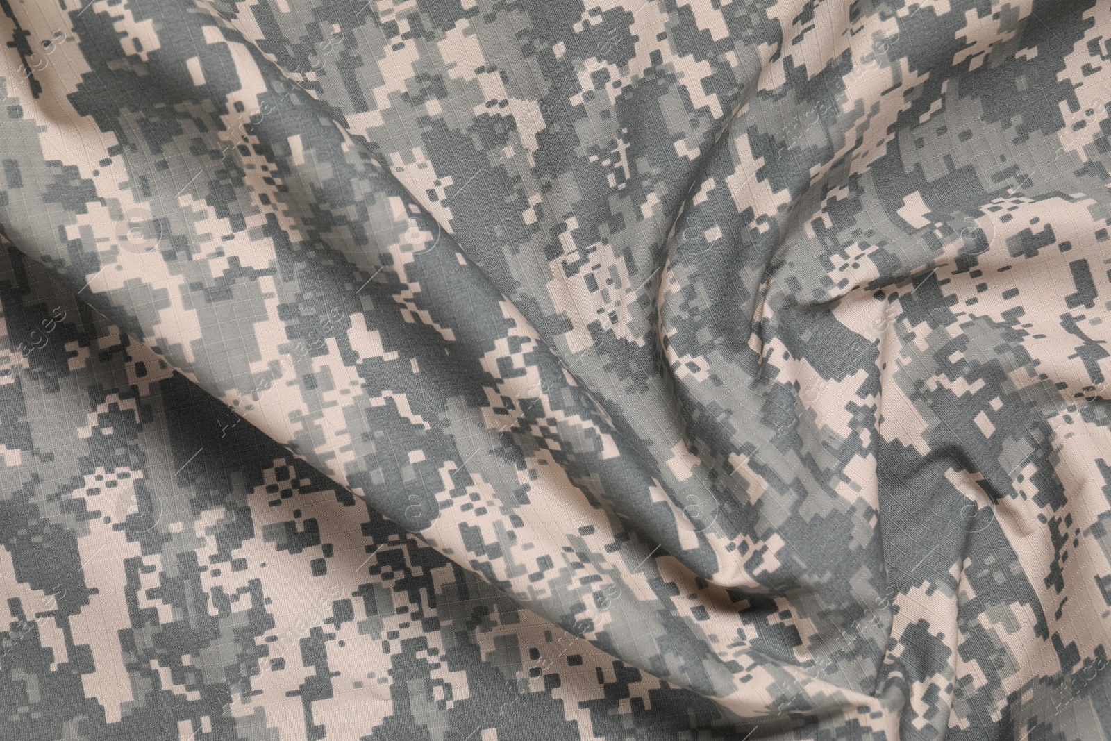 Photo of Texture of crumpled camouflage fabric as background, top view