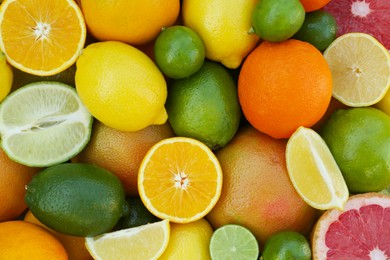 Photo of Different fresh citrus fruits as background, top view