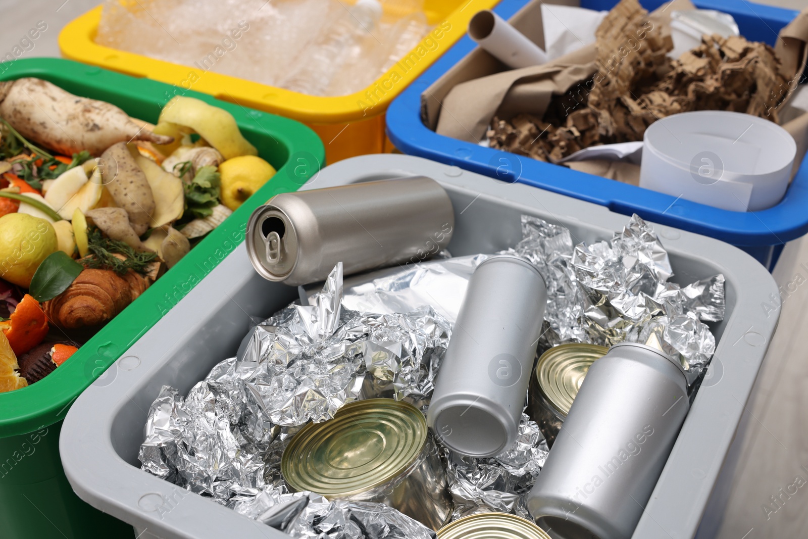 Photo of Garbage sorting. Full trash bins for separate waste collection indoors, closeup