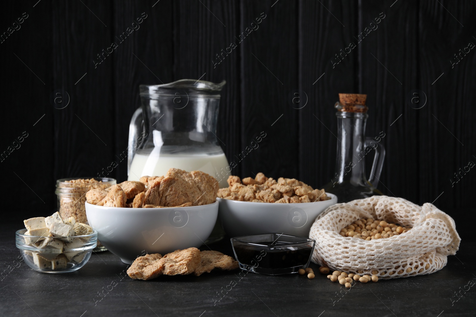 Photo of Different organic soy products on black table