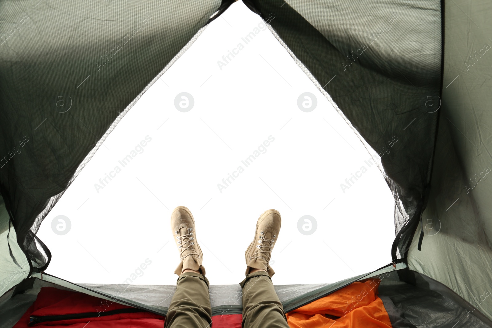 Photo of Closeup of female in camping tent on white background, view from inside