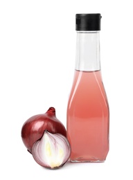 Glass bottle of onion syrup and fresh ingredient on white background