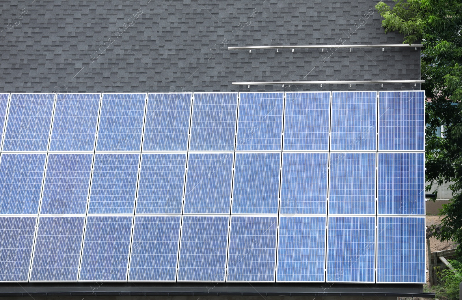 Photo of Building with installed solar panels on roof. Alternative energy source