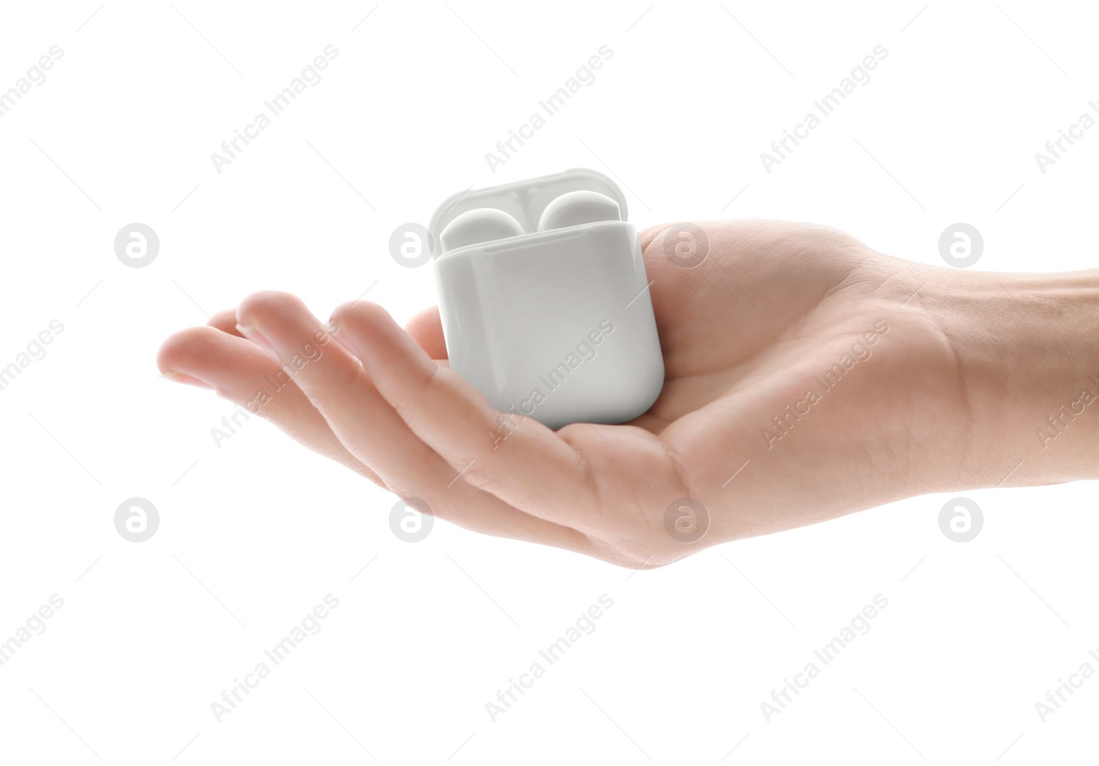 Photo of Woman holding modern wireless earphones in charging case on white background, closeup