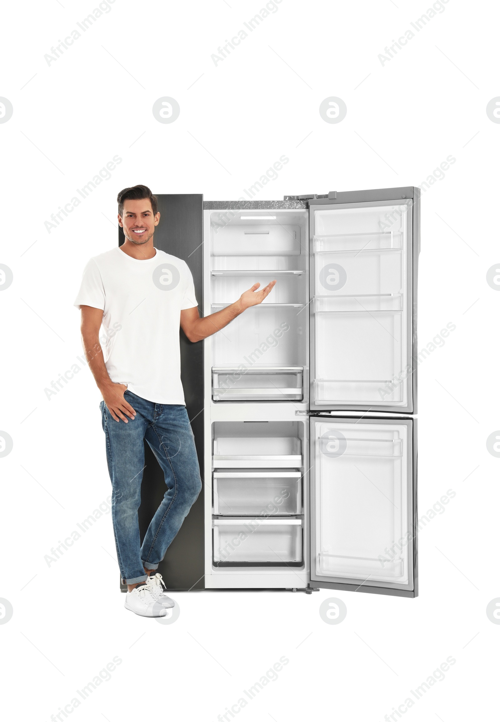 Photo of Man near open empty refrigerator on white background