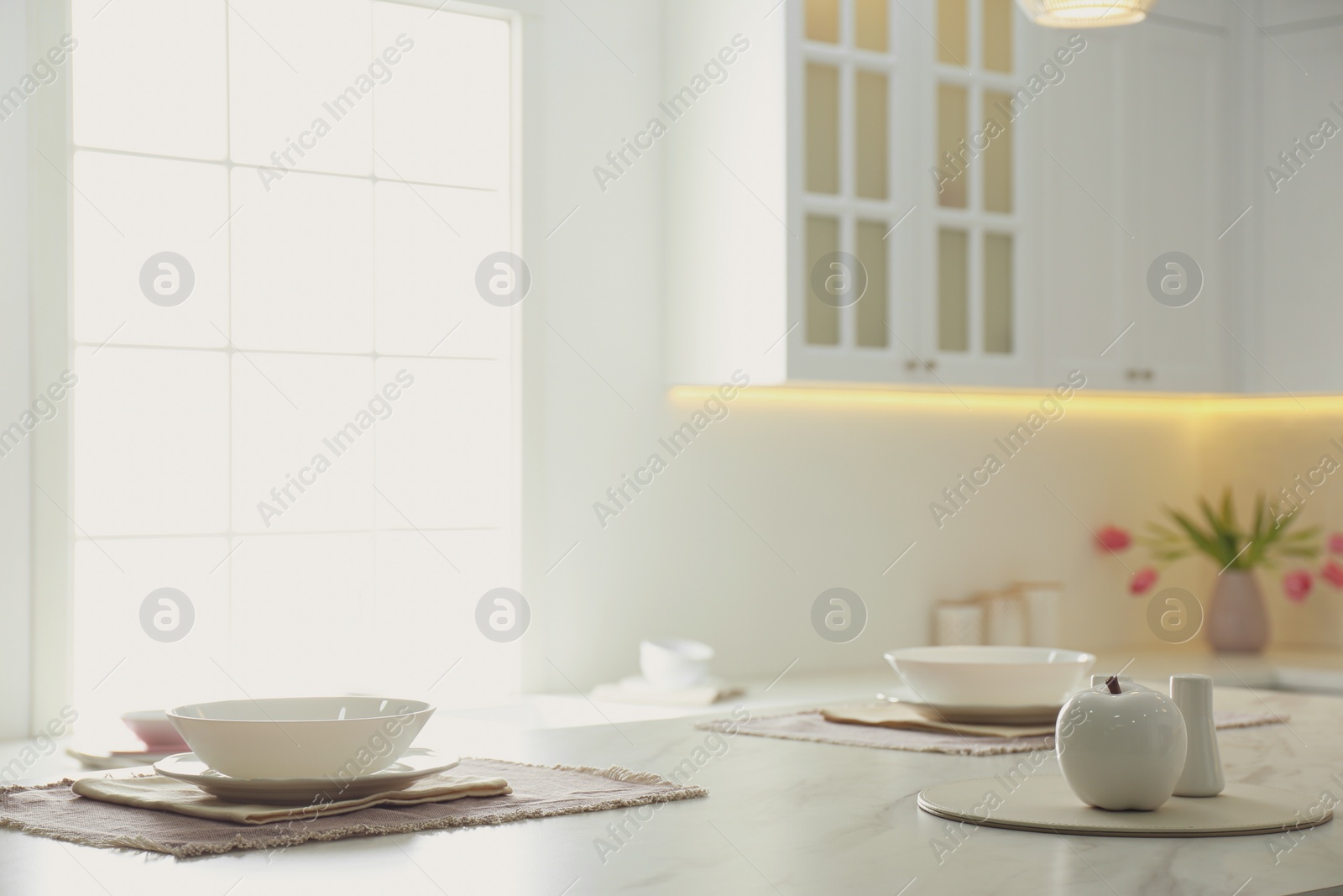 Photo of Elegant table setting in stylish kitchen interior